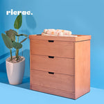 Rafand baby dresser changer with three drawers, elegant design, and baby essentials on top.