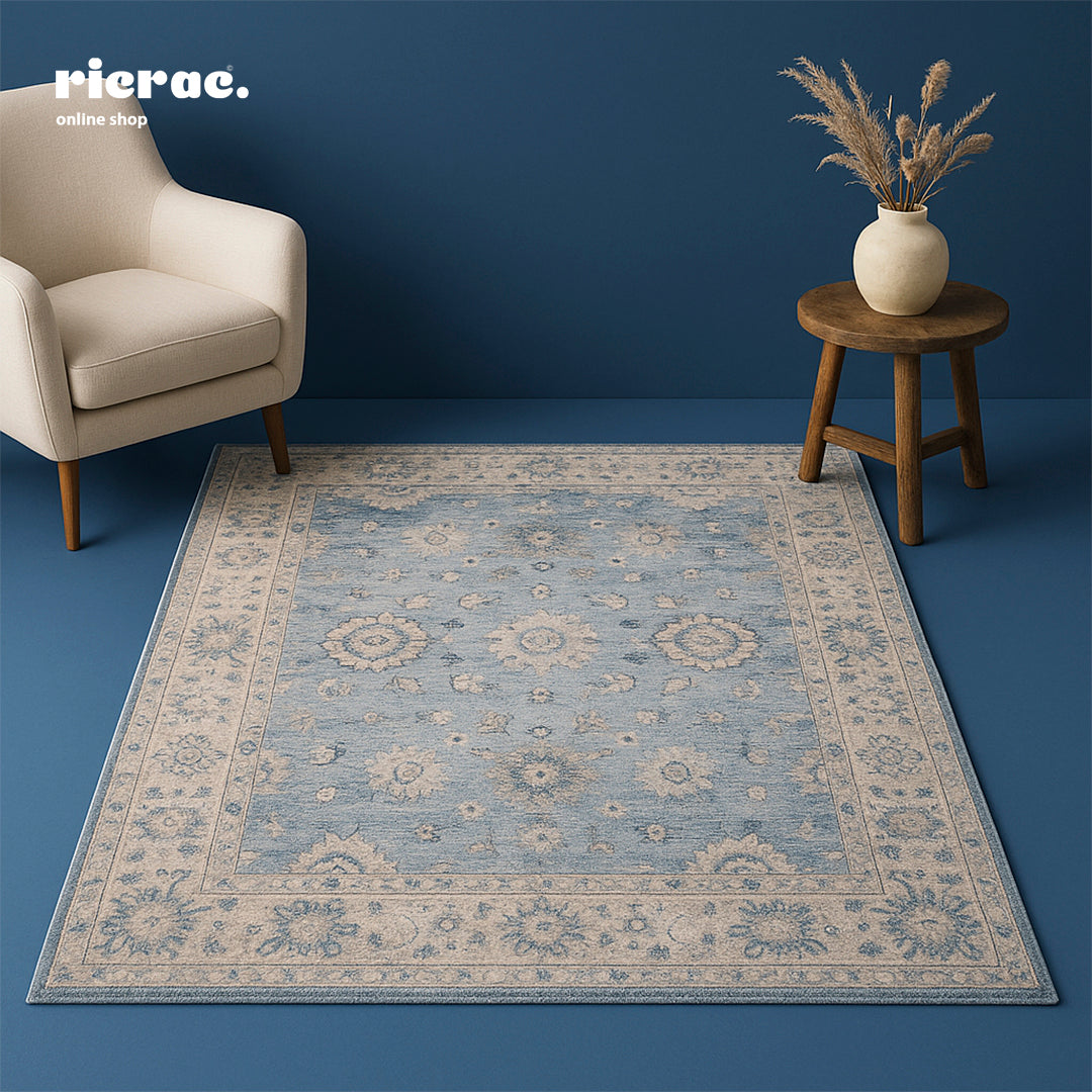 Ravello- Printed Chenille cotton with Ganga Rug on a blue floor next to a chair and side table, showcasing elegant design.