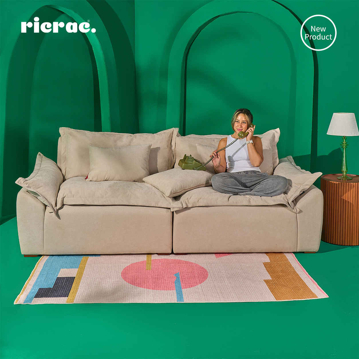 Rabou- Super Soft 2 Seaters Sofa featuring a woman relaxing with a phone on a colorful rug.