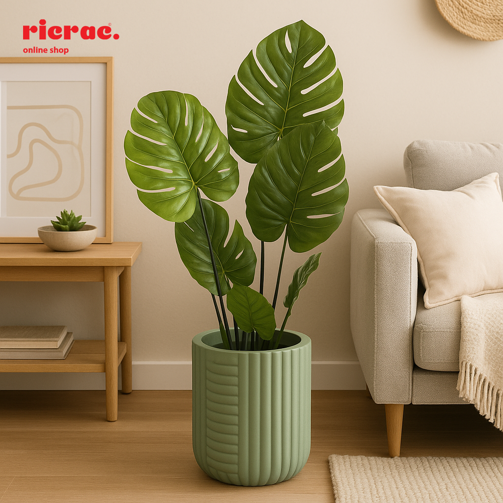 Ravelli Fiberglass Pot with monstera leaves in a stylish living room setting, adding vibrant greenery and modern design.