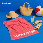 Radiant Sun Kissed-Microfiber Towel on a beach setup with sunglasses, hat, and beach accessories.