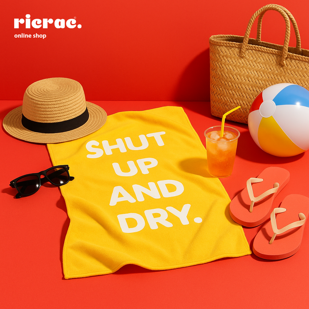 Riot Microfiber Towel with bold message, perfect for beach or poolside relaxation.