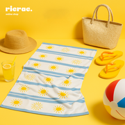 Risa -Microfiber Towel on a sunny background with a beach hat, flip flops, and a colorful beach ball.