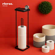 Rosan- Paper Towel Metal Stand displaying rolls of paper towels with a clock and decorative baskets on a vibrant background.