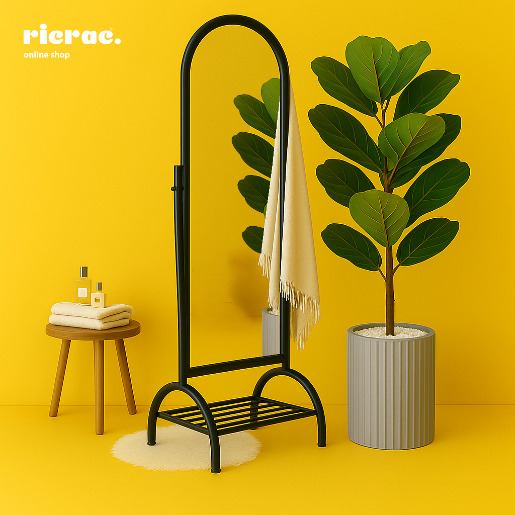 Rinova- Metal Mirror displayed with towels and a stylish plant in a bright yellow interior setting.