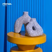 Refant Clay Accessory on yellow table, unique shapes and patterns, perfect for decor.