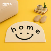 Rani hand tufted rug with a smiley face design and cheerful 'home' message in a cozy living space.