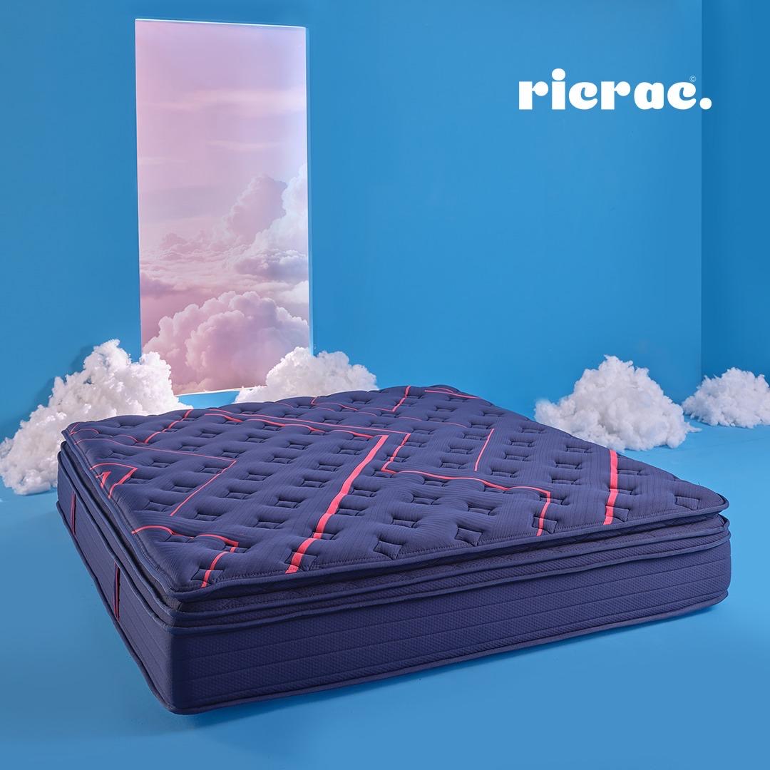 Royal Double Layer Memory Foam & Natural Latex Pocket Spring Mattress on a blue background with cloud accents.