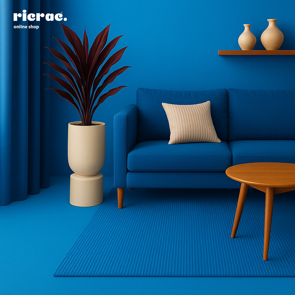 Rondara Fiberglass Pot with plant in a modern blue living room setting featuring a blue couch and wooden coffee table.