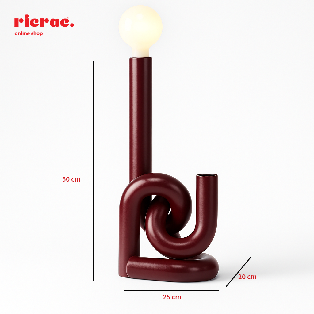 Minimalistic metal lighting unit with unique twisted design and soft glowing bulb, dimensions 50 cm height, 25 cm width, 20 cm depth.