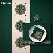 Waterproof Tabletop Set Arabesque pattern in green with placemats, table runner, coasters, and napkin on a dining table.