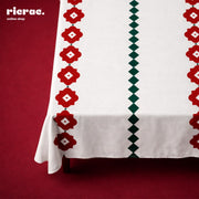 Waterproof table cover with red flower motif and green dots, ideal for Ramadan meals, featuring chenille cotton Ganga rug.
