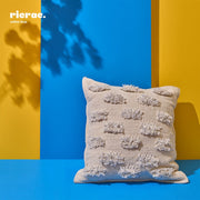 Kilim Cushion on a vibrant blue and yellow background, showcasing its intricate patterns and bohemian charm.