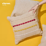 handcrafted kilim cushion in beige with red and yellow accents on a yellow background