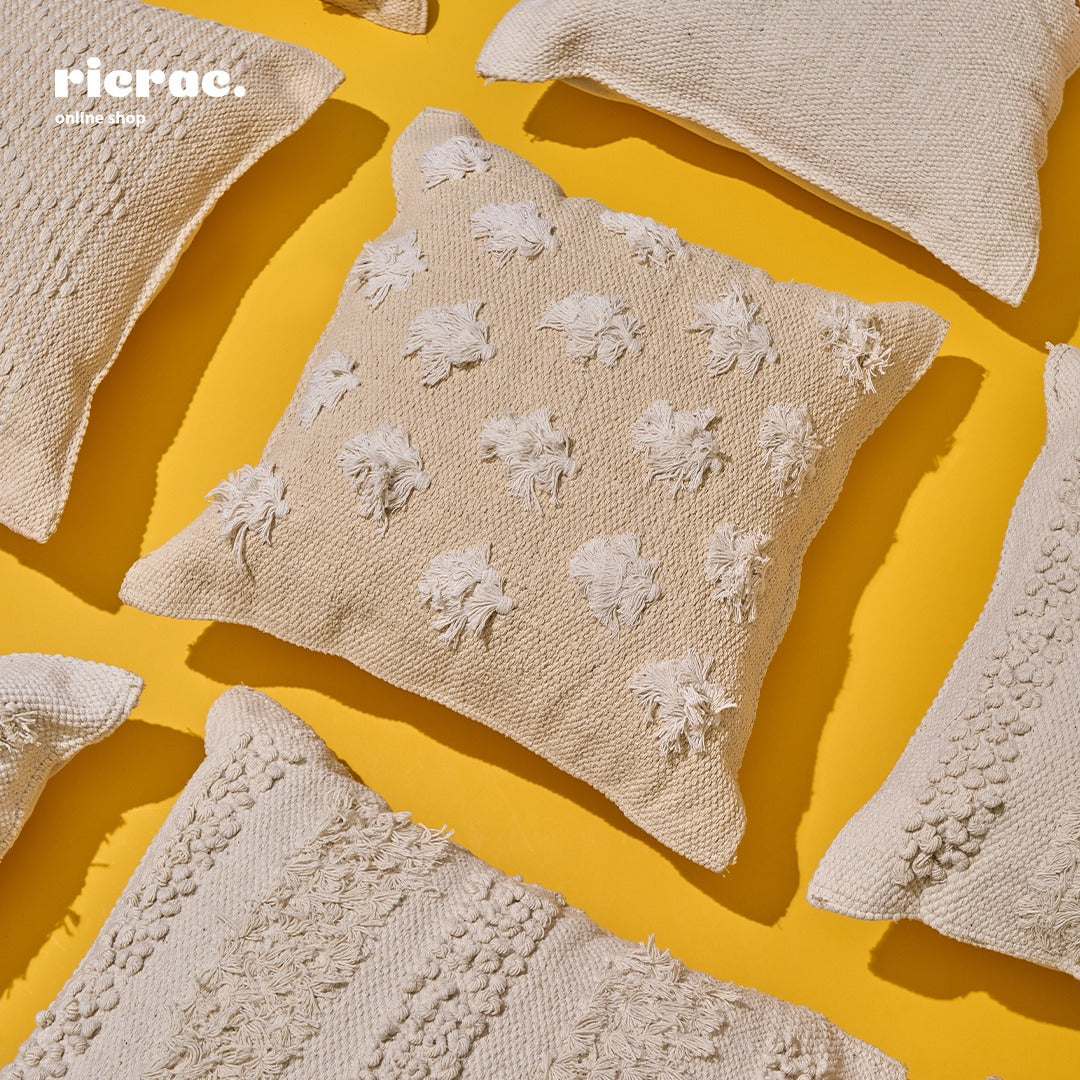 Kilim cushion in beige with textured patterns on a bright yellow background, perfect for adding bohemian style to any space.