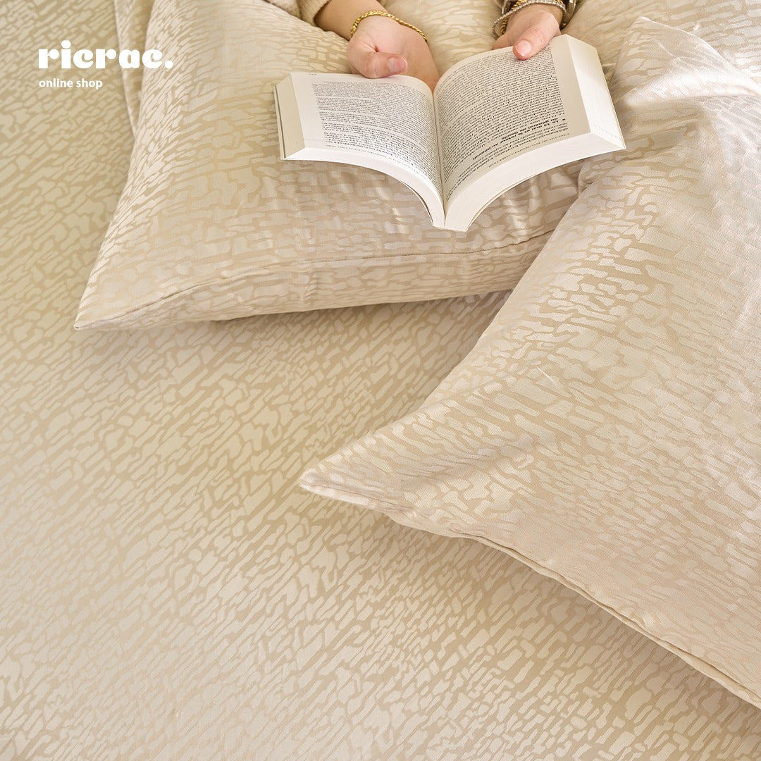 Jacquard Poly Cotton- TC200- Bricks Bed Sheet Set with 2 Pillow cases on a bed with a person reading a book.