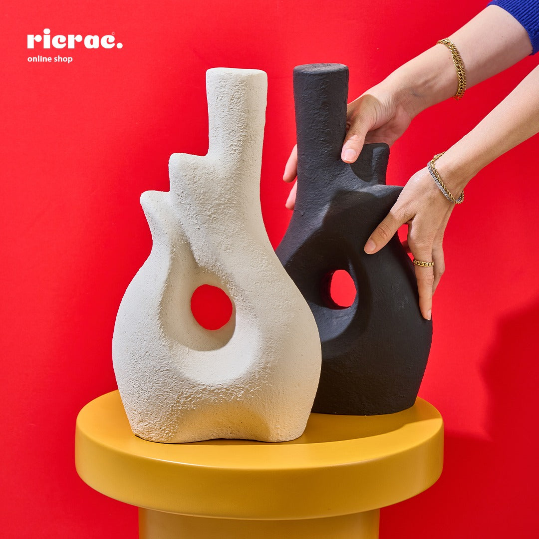 Handcrafted pottery vases in black and white, adding elegance to any decor, perfect for fresh blooms or as art pieces.