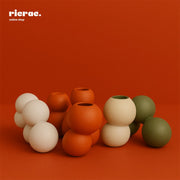 Rondo- Clustered Orb Clay Vase arrangement with colorful orbs on a vibrant background.