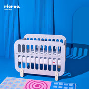 Refook- Baby Cot Bed with a side changing unit displayed against a blue background, featuring a modern design.