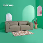 Reemo 2 Seater Sofa in a vibrant green living room, featuring a stylish rug and modern decor.