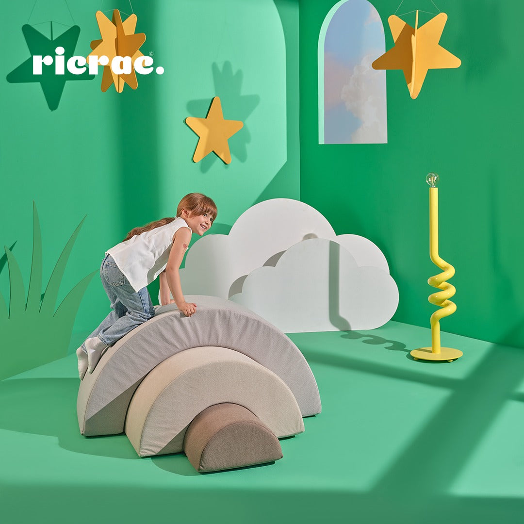 Child playing on Ranzula- Multi functional Kids Set in a colorful playroom with green walls and fun decor.