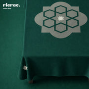 Waterproof Table Cover Arabesque Pattern Green on a table, showcasing a stylish geometric design.