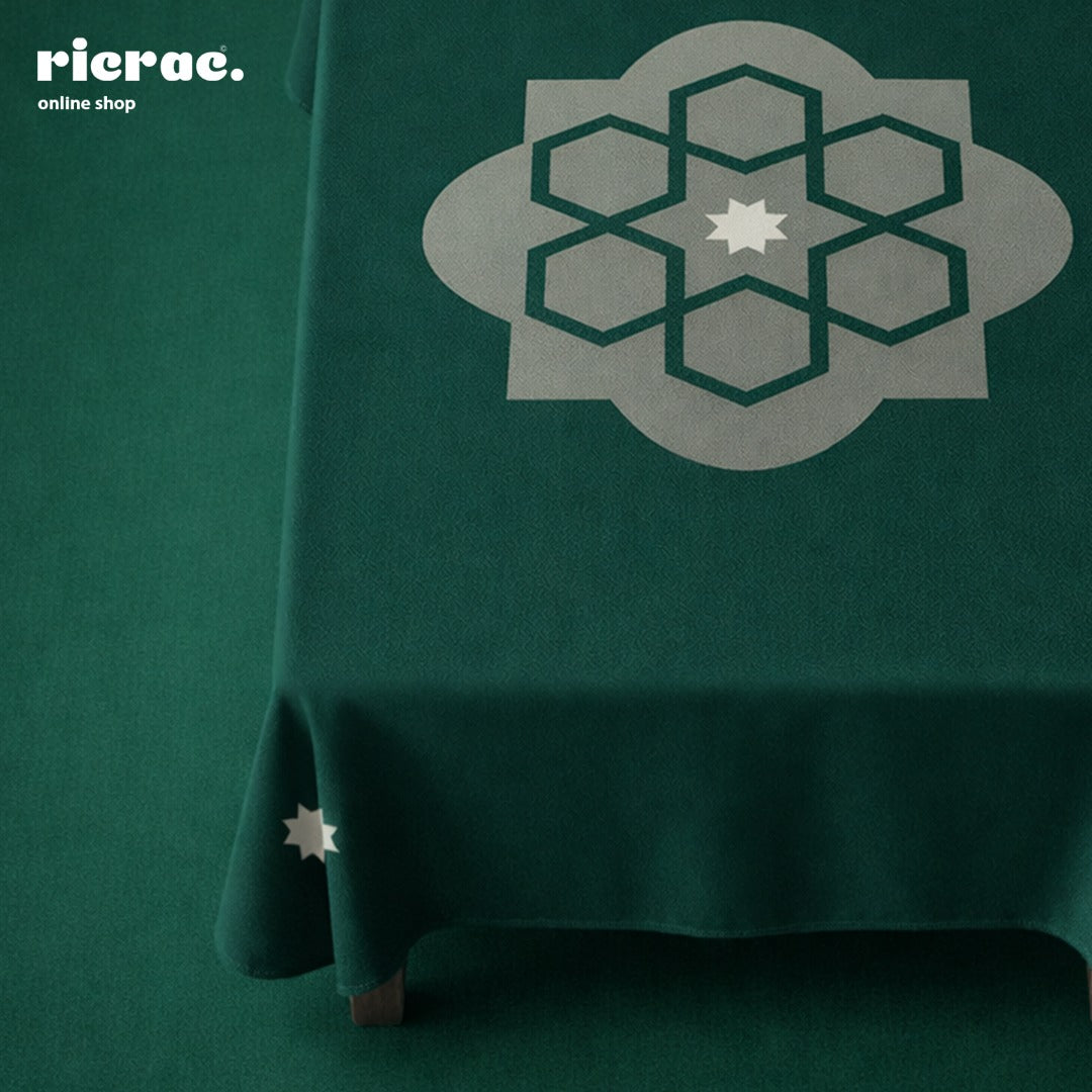 Waterproof Table Cover Arabesque Pattern Green on a table, showcasing a stylish geometric design.