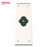 Waterproof Moroccan table runner featuring a decorative design in green on a cream background.