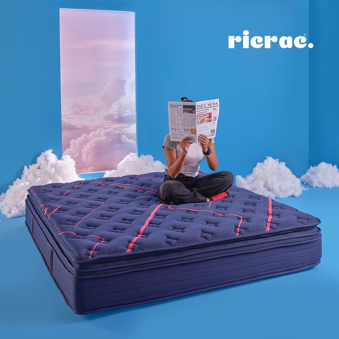 Royal Double Layer Memory Foam & Natural Latex Pocket Spring Mattress with a person reading on top.