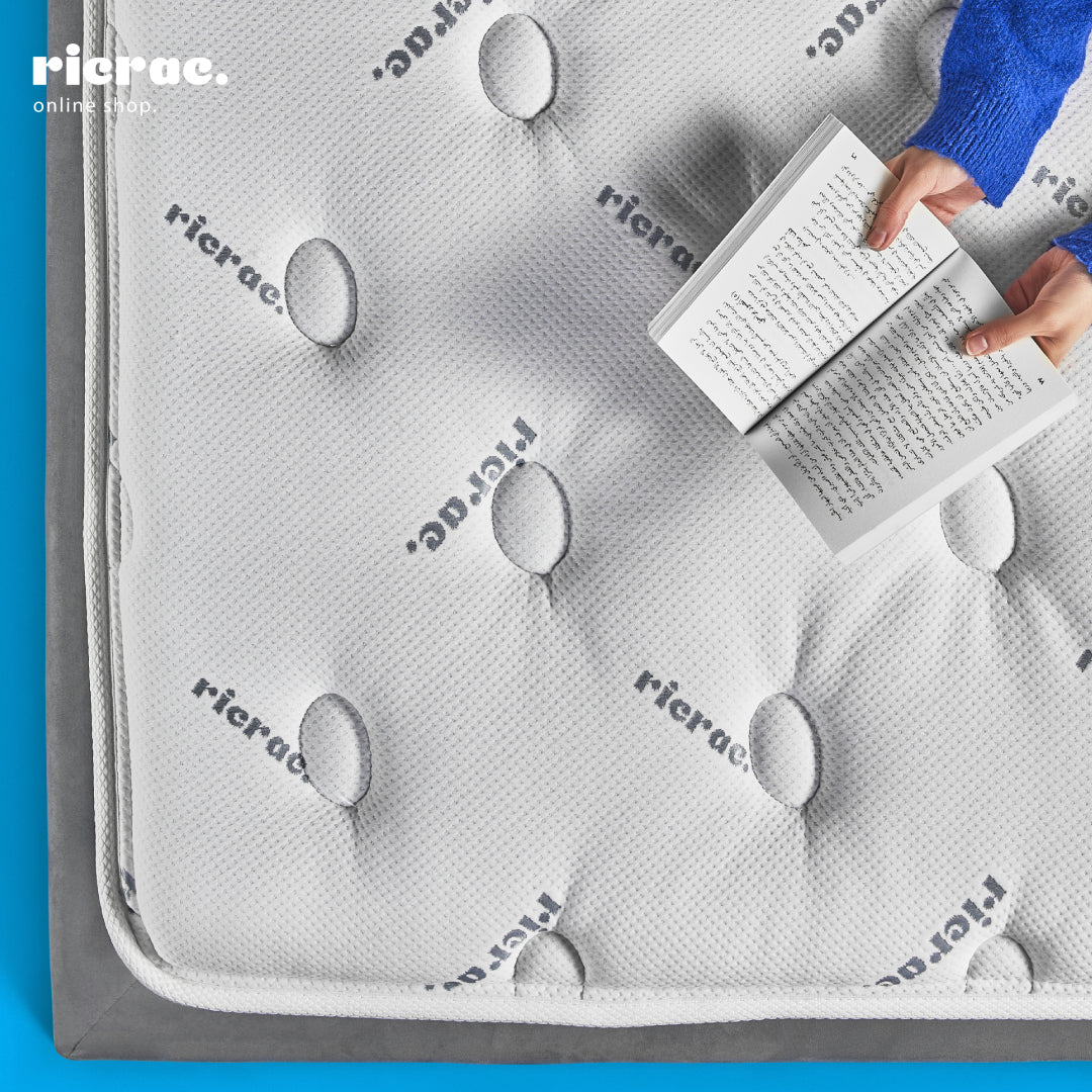 Soft Foam Pocket Spring System Mattress- RTS displayed with a person reading a book on top of it.